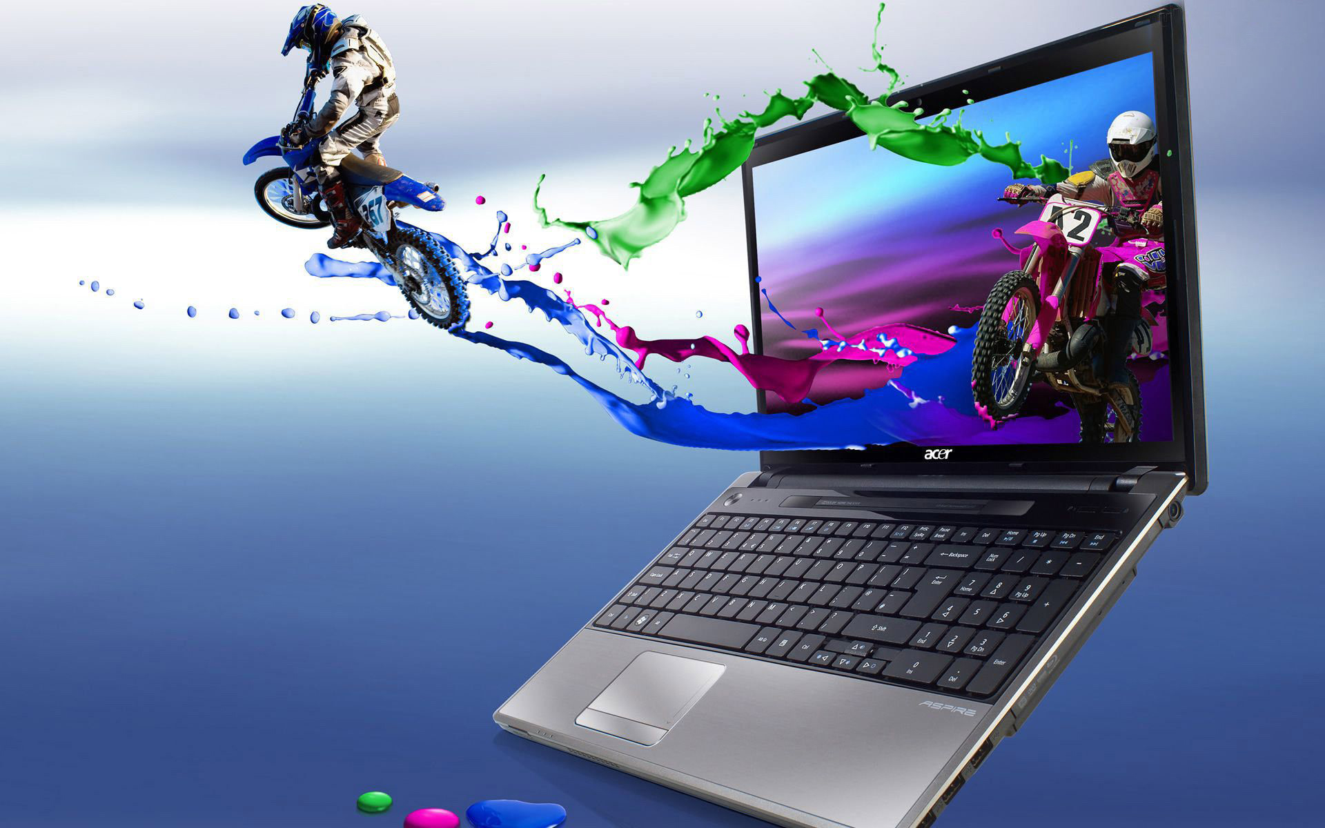 Acer Aspire laptop displaying a vibrant motocross scene with colorful paint splashes