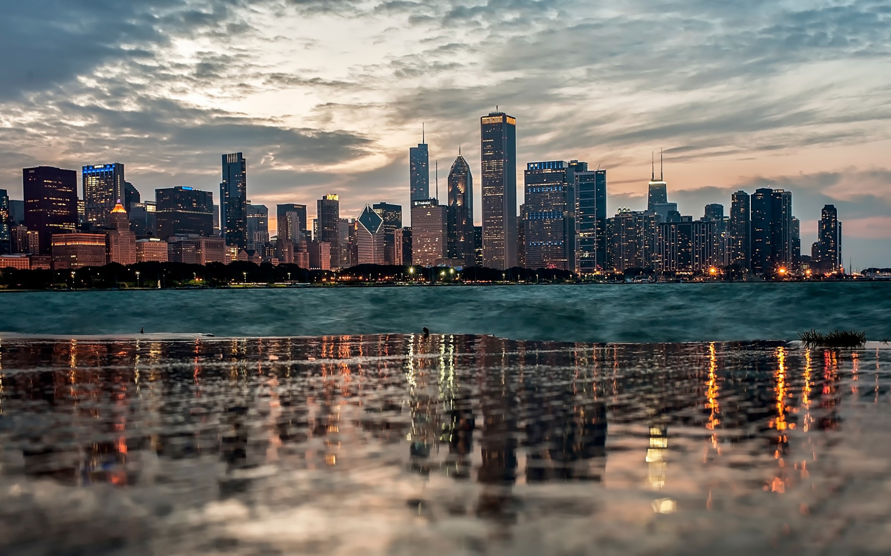 Chicago skyline at dusk reflected in wet pavement