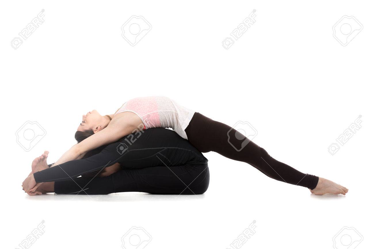 Sporty Young Couple On White Background Doing Acroyoga Fitness