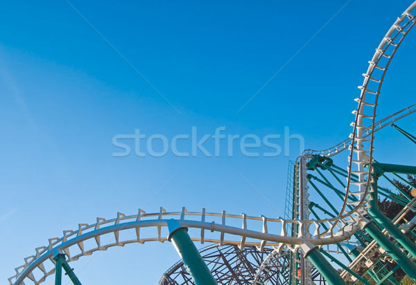 Picture Of Roller Coaster High In The Sky Blue Background
