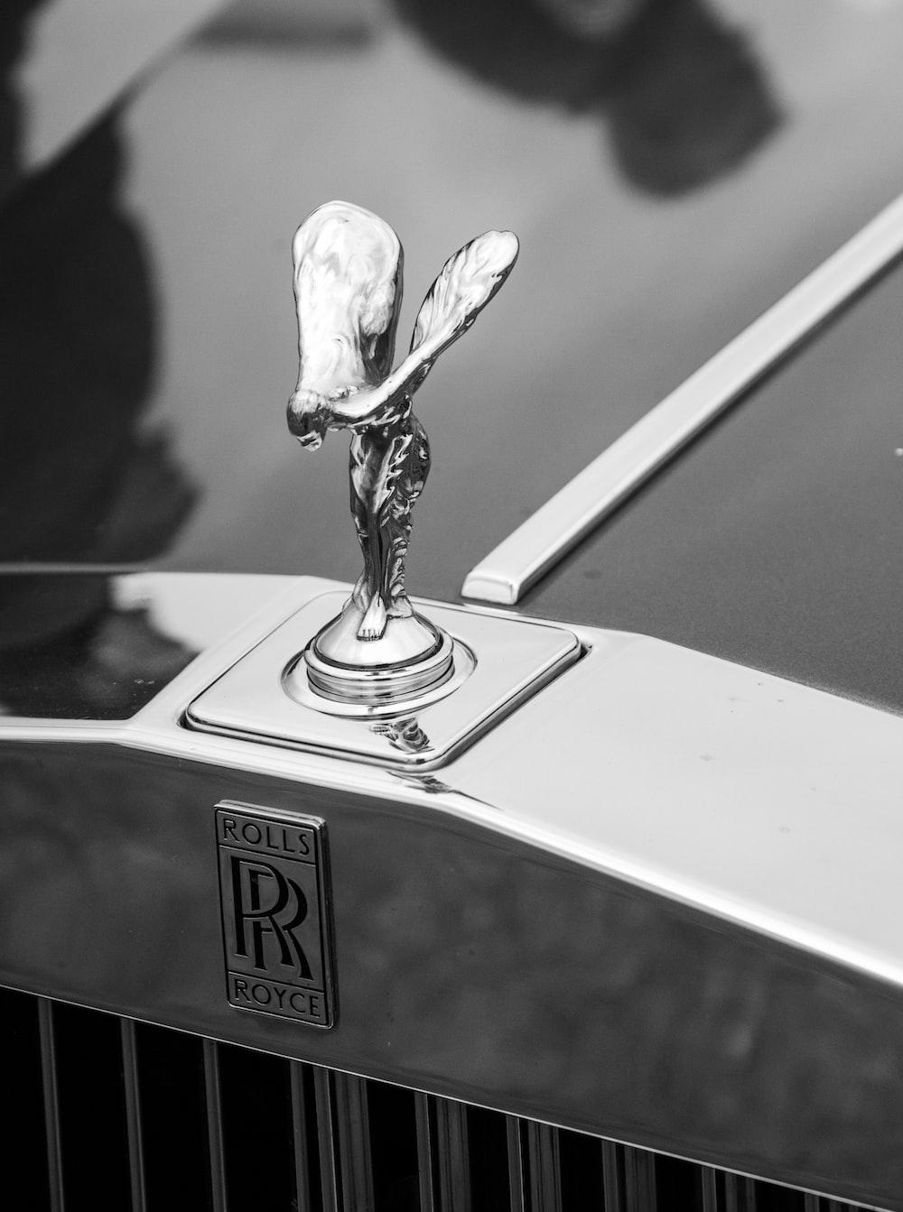 A Black And White Photo Of Rolls Royce Emblem Car