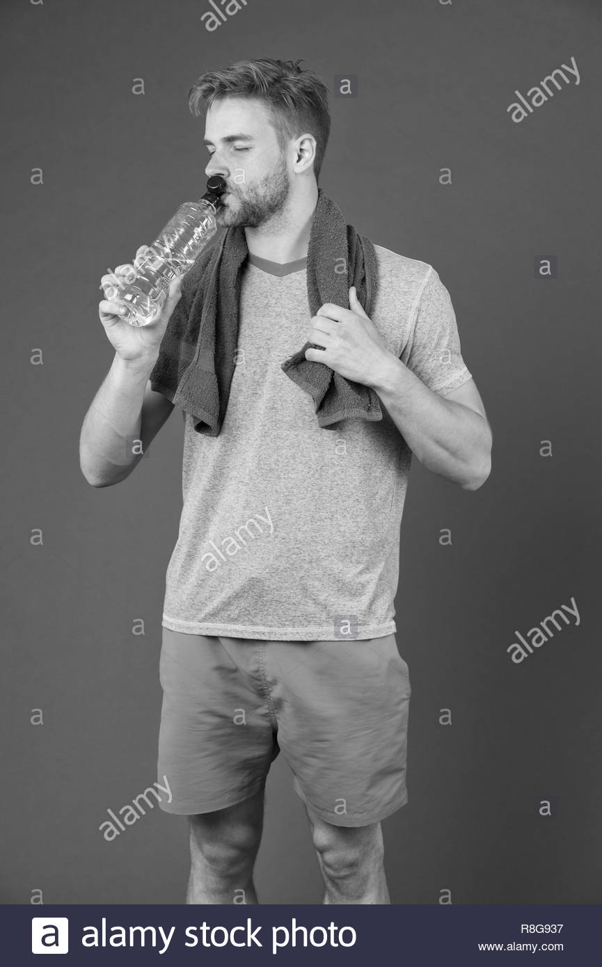 Man Drink Water After Training On Violet Background Thirsty