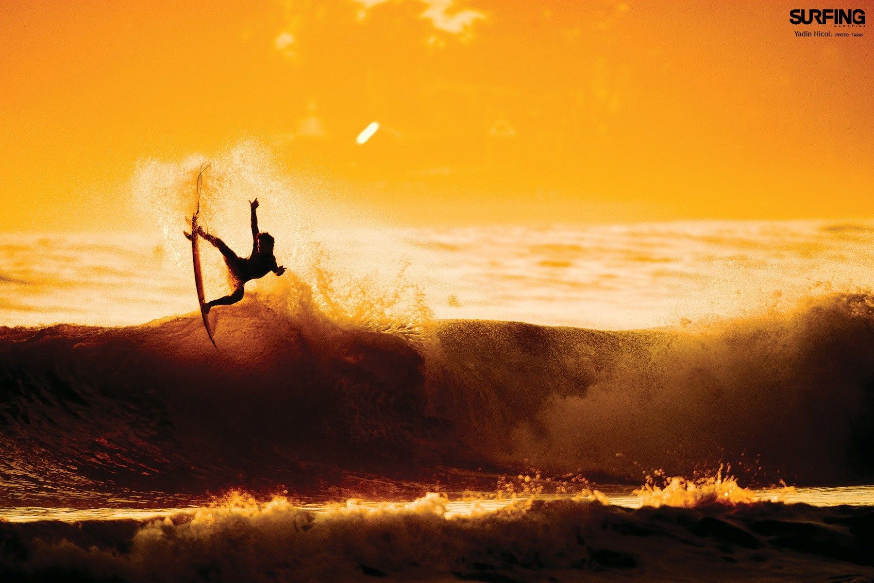 Silhouetted surfer performs an aerial maneuver on a wave at sunset, Surfing Wallpaper