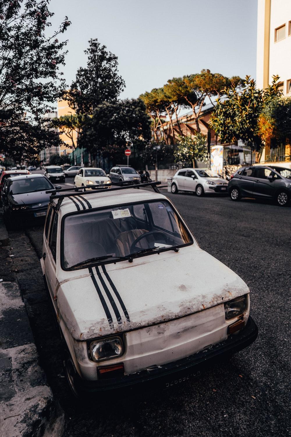 White Car Parked On The Side Of Road Photo Napoli Image