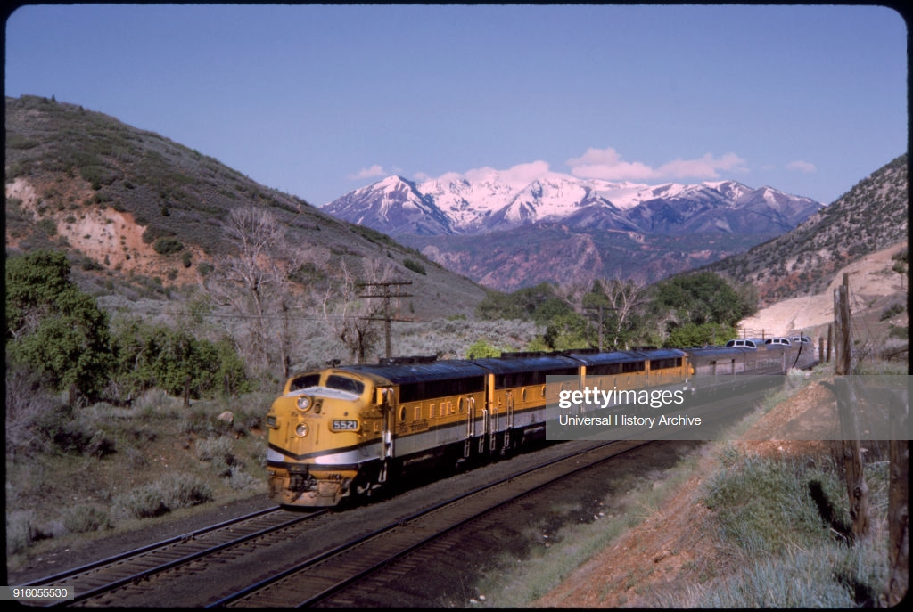 California Zephyr Train With Snow Capped Mountains In Background