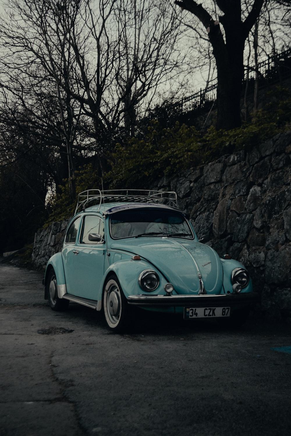 Teal Volkswagen Beetle Parked Beside Tree Photo Car Image