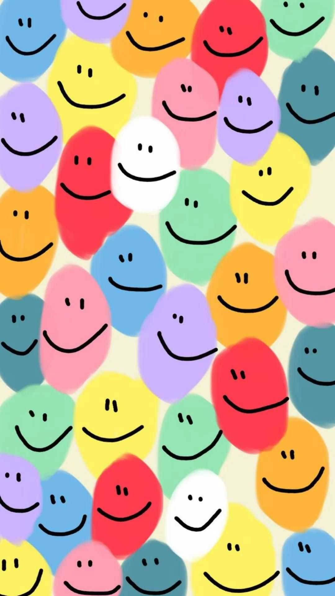 A cheerful wallpaper filled with colorful smiley faces on a light yellow background