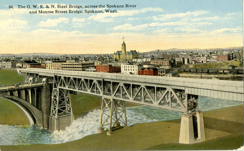 Bridge Crossing The Spokane River With City In Background