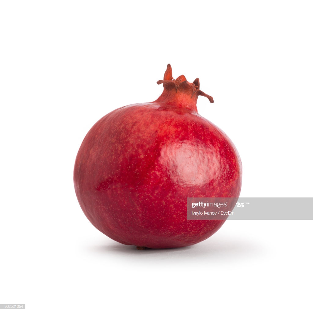 Closeup Of Pomegranate Against White Background High Res Stock