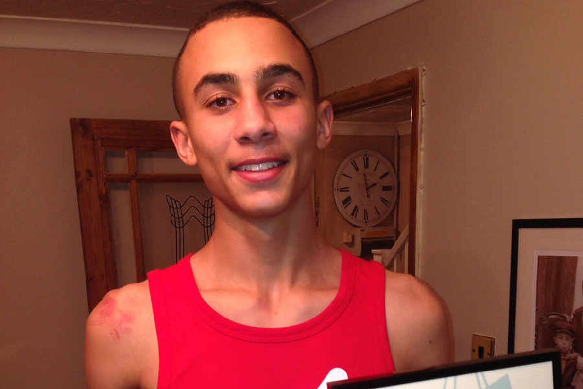 Benjamin Whittaker smiling for the camera in a red tank top