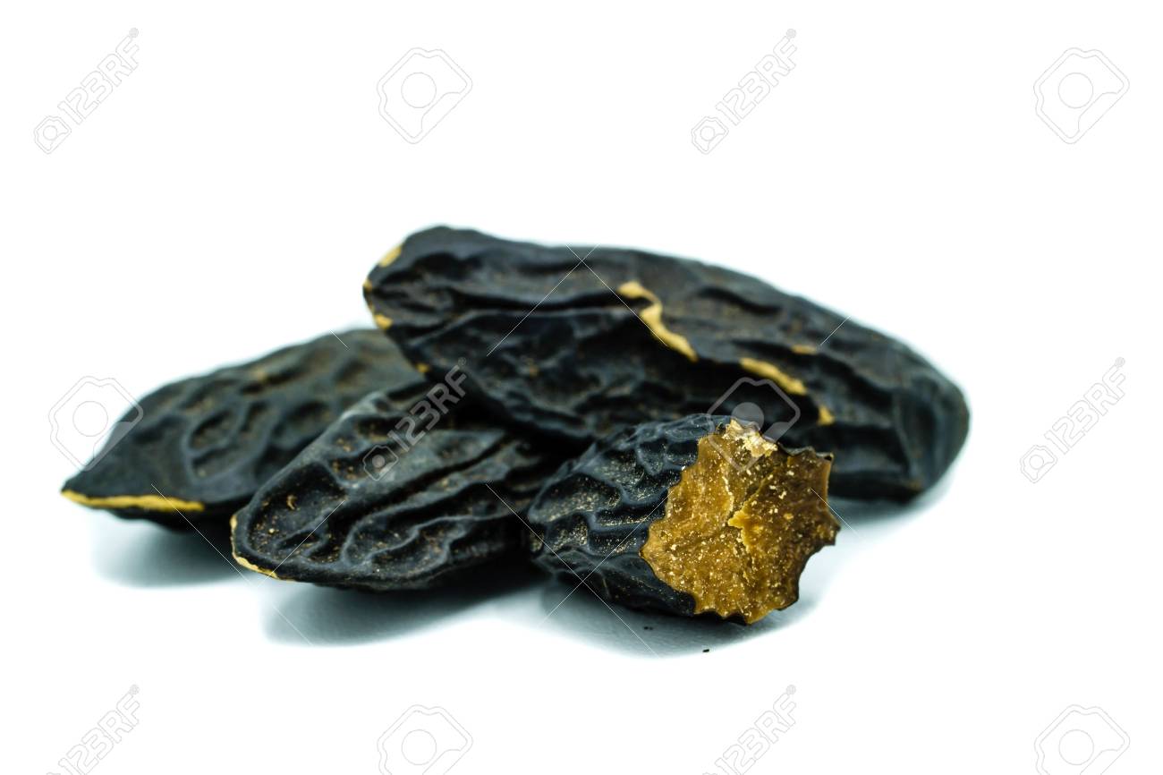Three Whole Tonka Beans And One Cut Open Isolated On White