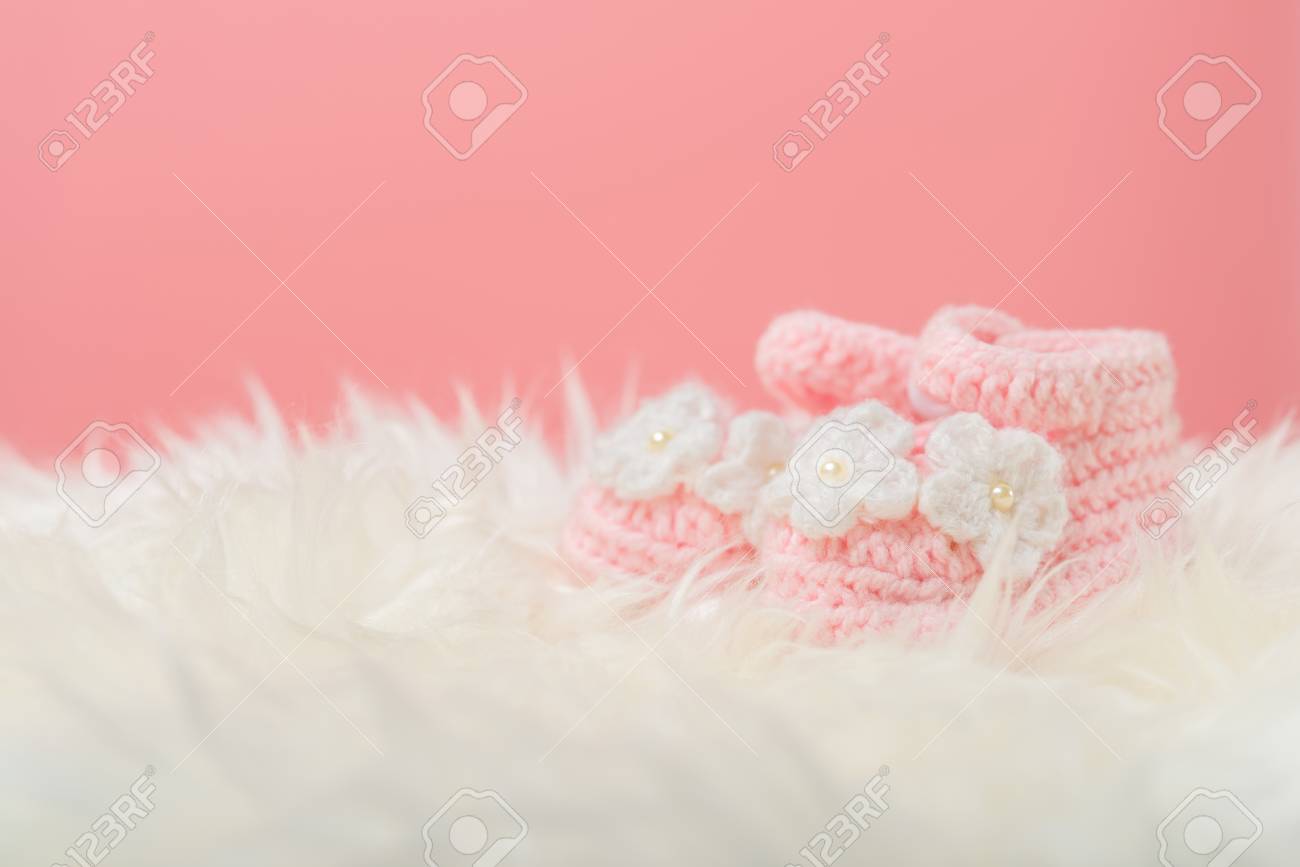 Close Up Baby Girl Knitted Shoes On White Blanket Background Happy