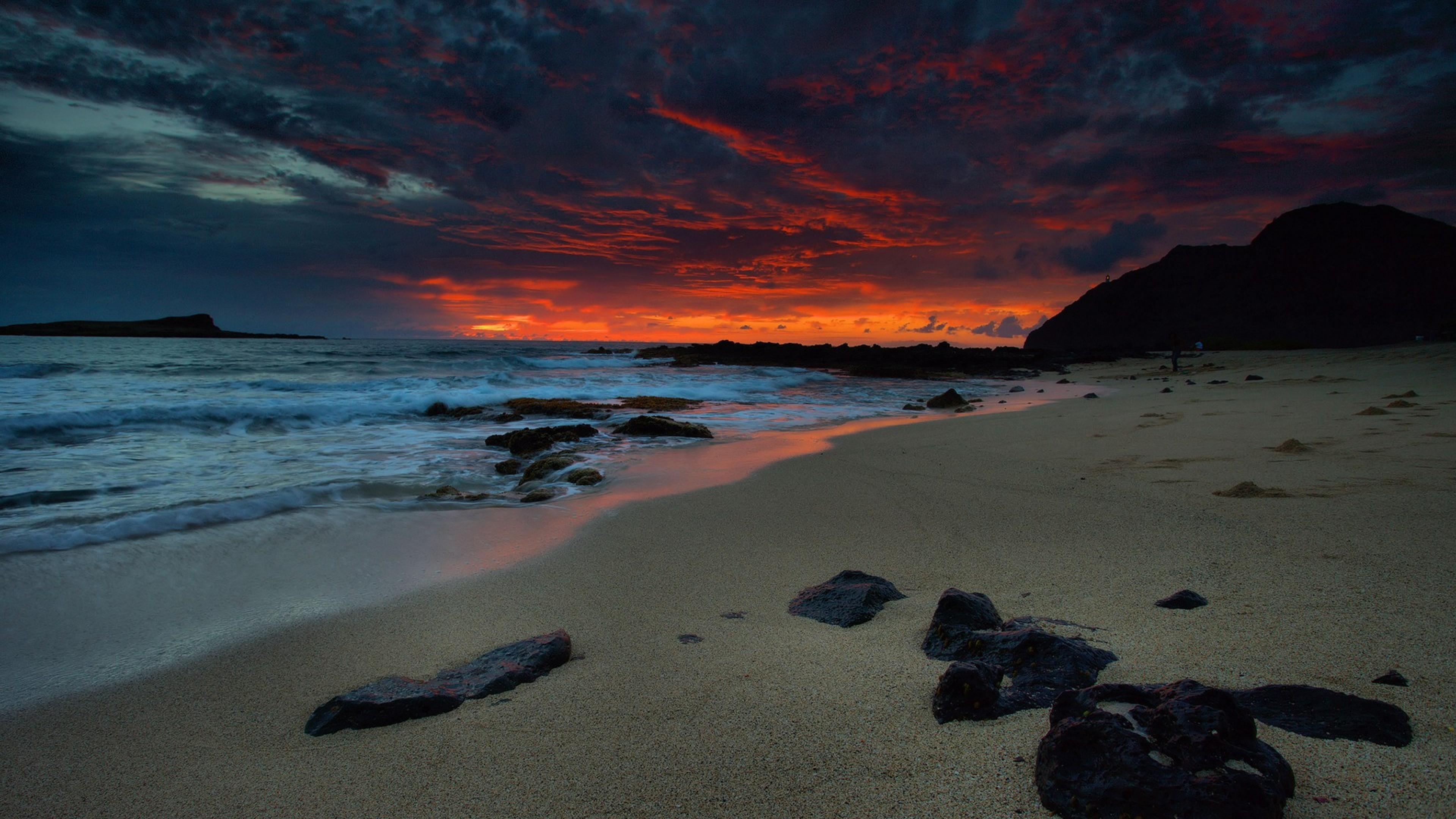 Fiery Sunset over a Secluded Beach at Night