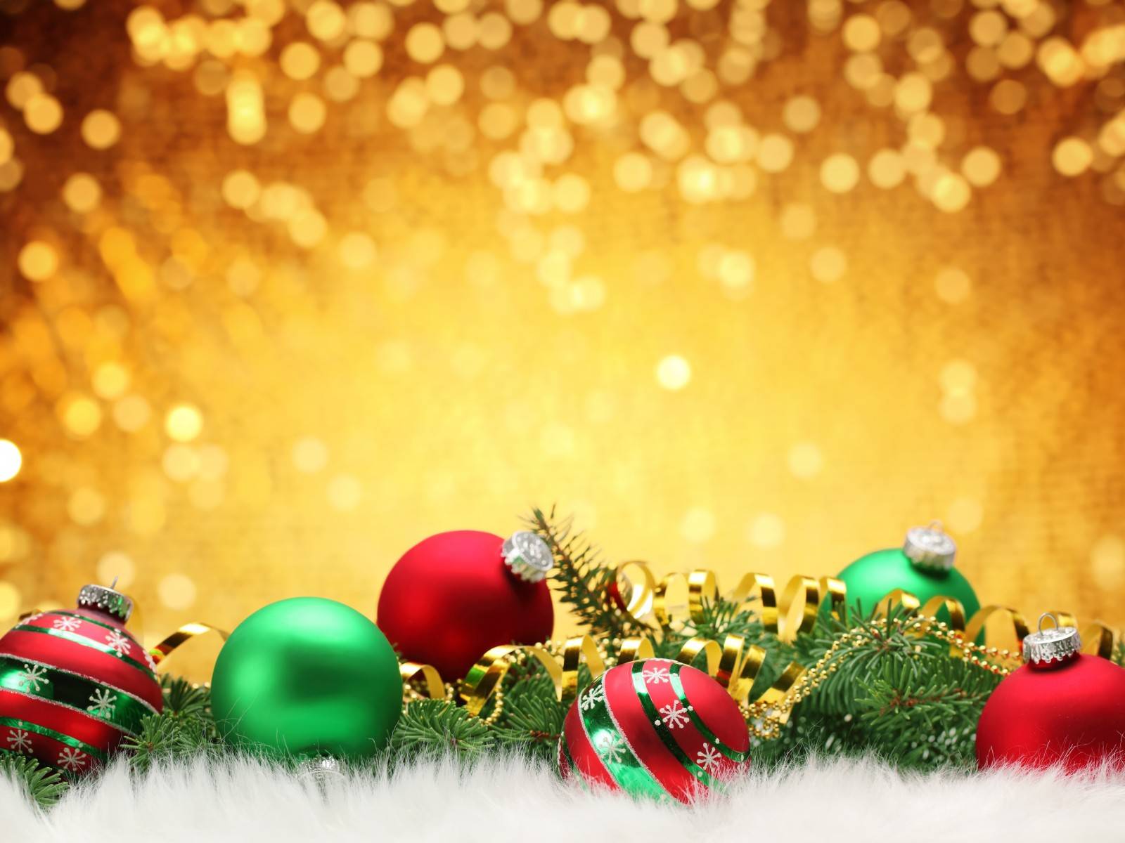 Festive Christmas ornaments and decorations on a sparkling gold background