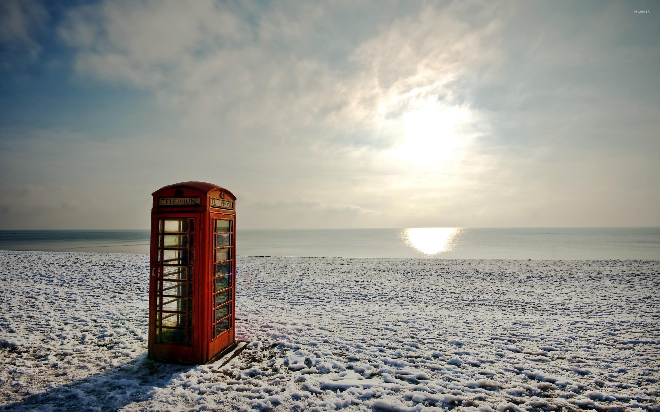Red Telephone Booth On A Winter Beach Wallpaper