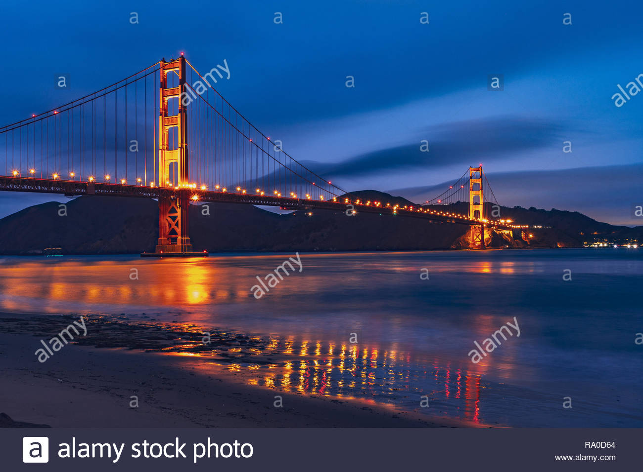 Nighttime view of Golden Gate Bridge reflected in the blurred