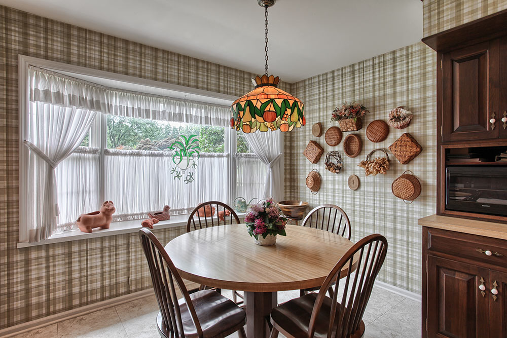 This kitchen has a country feel thanks mostly to the plaid wallpaper