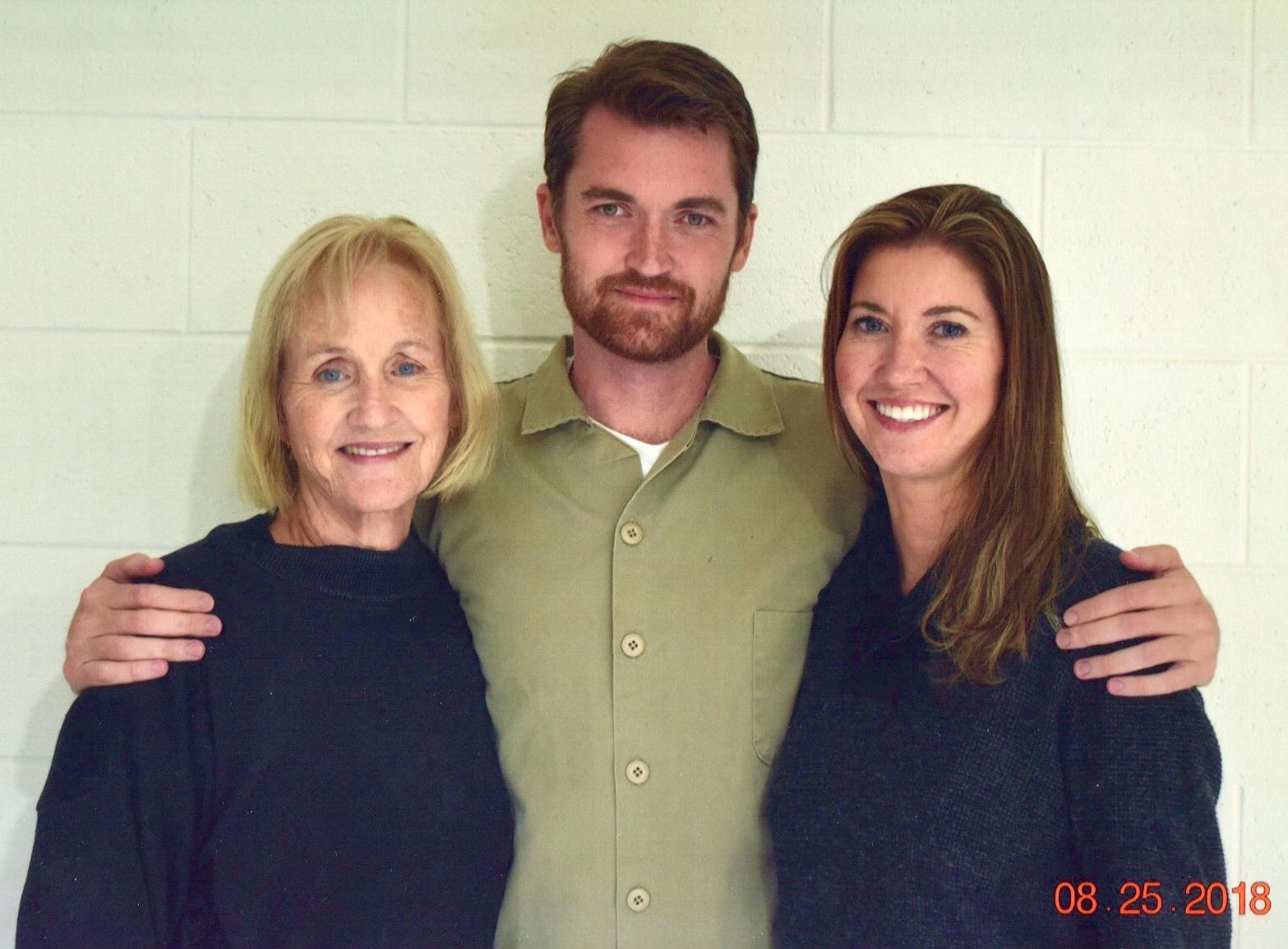 A family photo of three people posing together