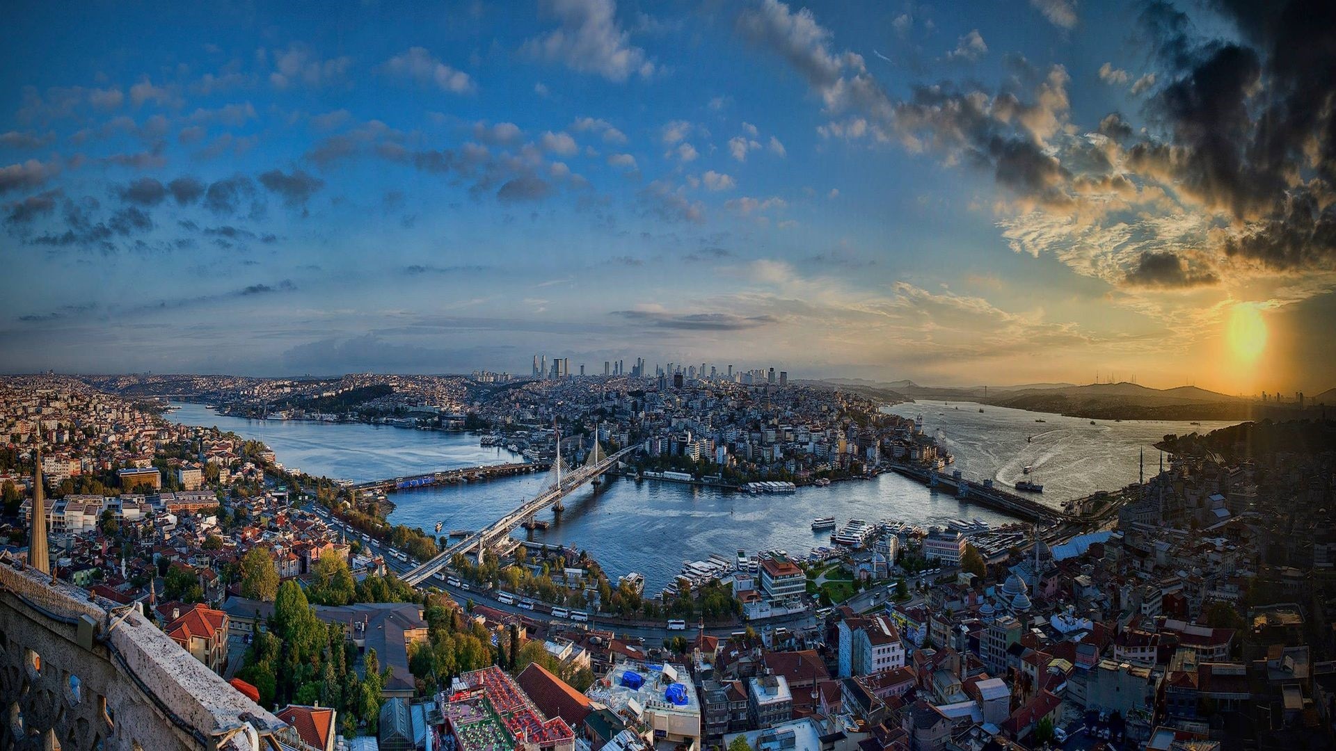 Panoramic view of Istanbul at sunset with the Golden Horn, bridges, and cityscape