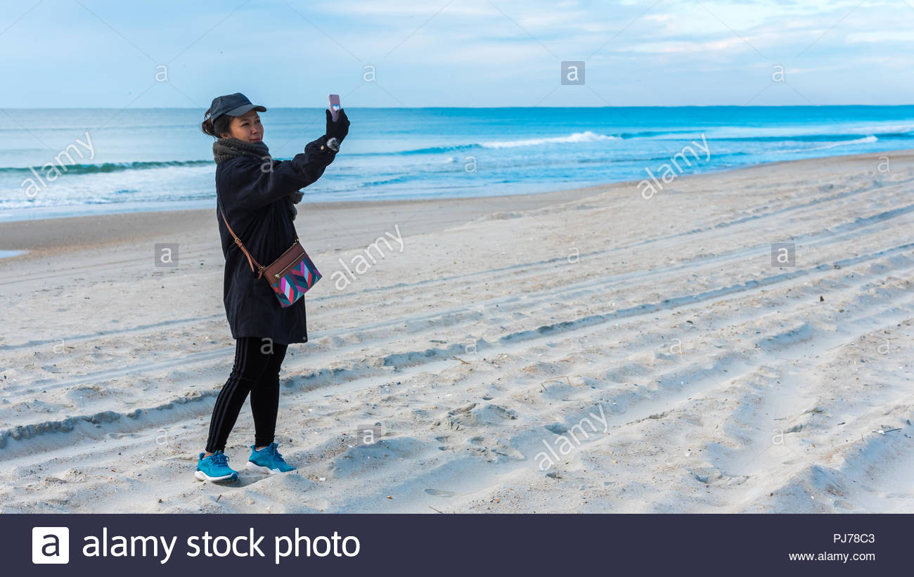 Woman On Beach At Emerald Isle Nc Taking Selfie With Ocean In