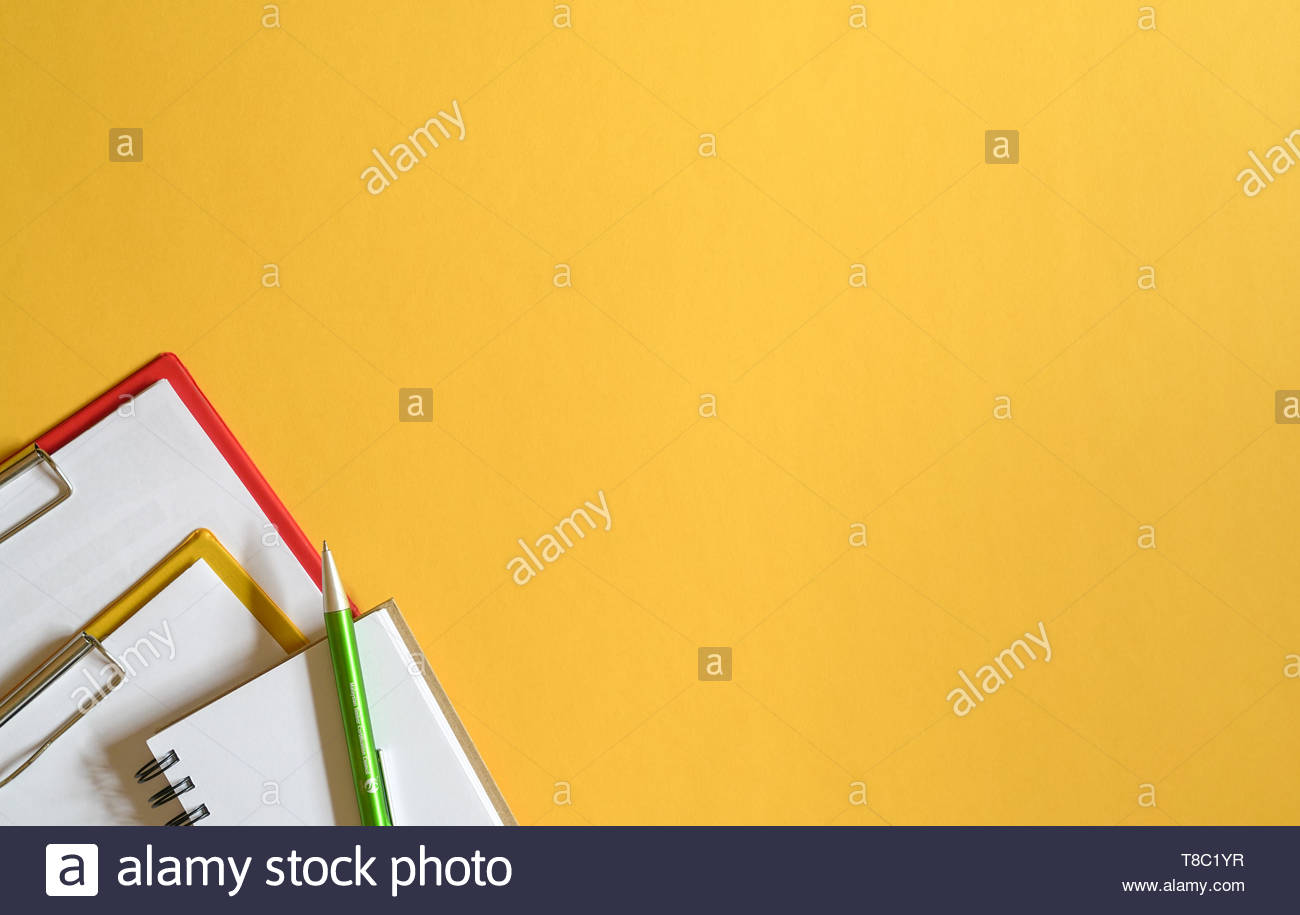 Clipboards Memo Pad And Green Pen On Yellow Top Or Desk