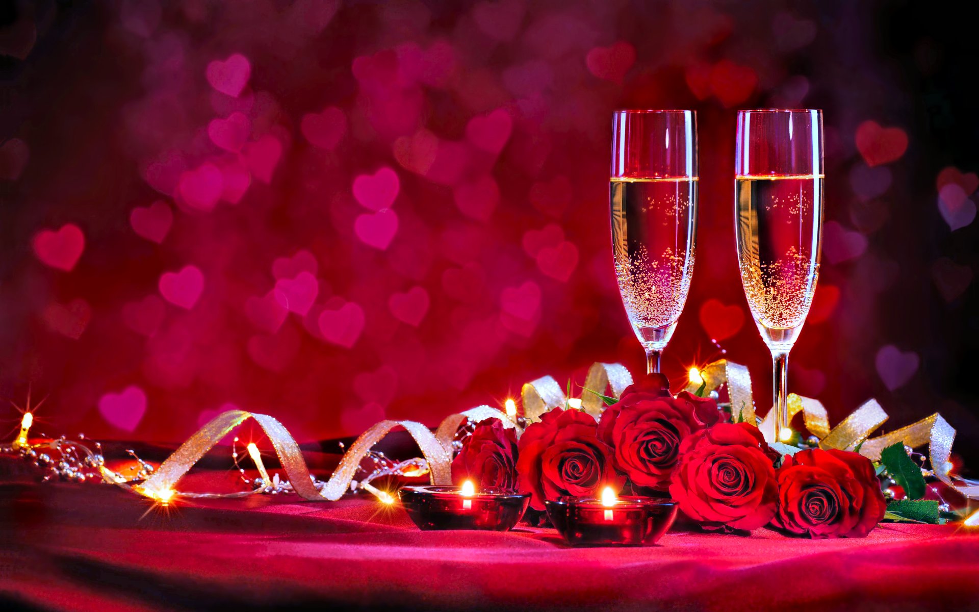 Romantic Valentine's Day setup with champagne flutes, red roses, and candles against a heart-shaped bokeh background