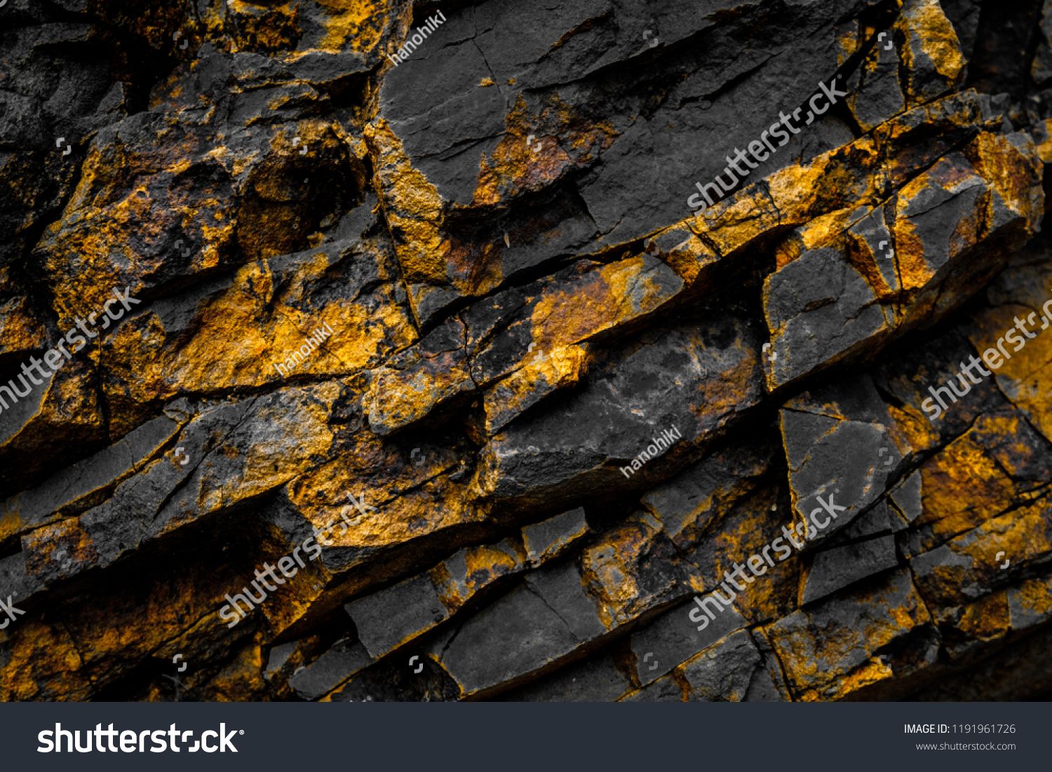 Black Rock Background With Gold Yellow Colored Rocks