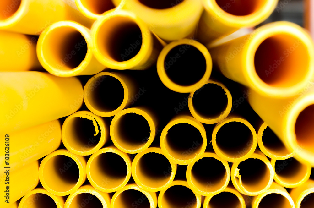 Yellow PVC tubes in storage Plastic tubes Background of PVC