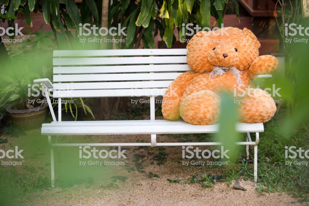 Alone Cute Teddy Bear Sitting On Wood And Snow Is Fallingwhite