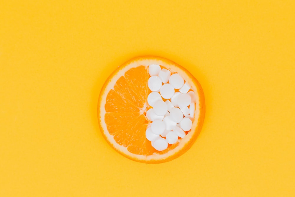 Orange Fruit Slices On Yellow Surface Photo Image