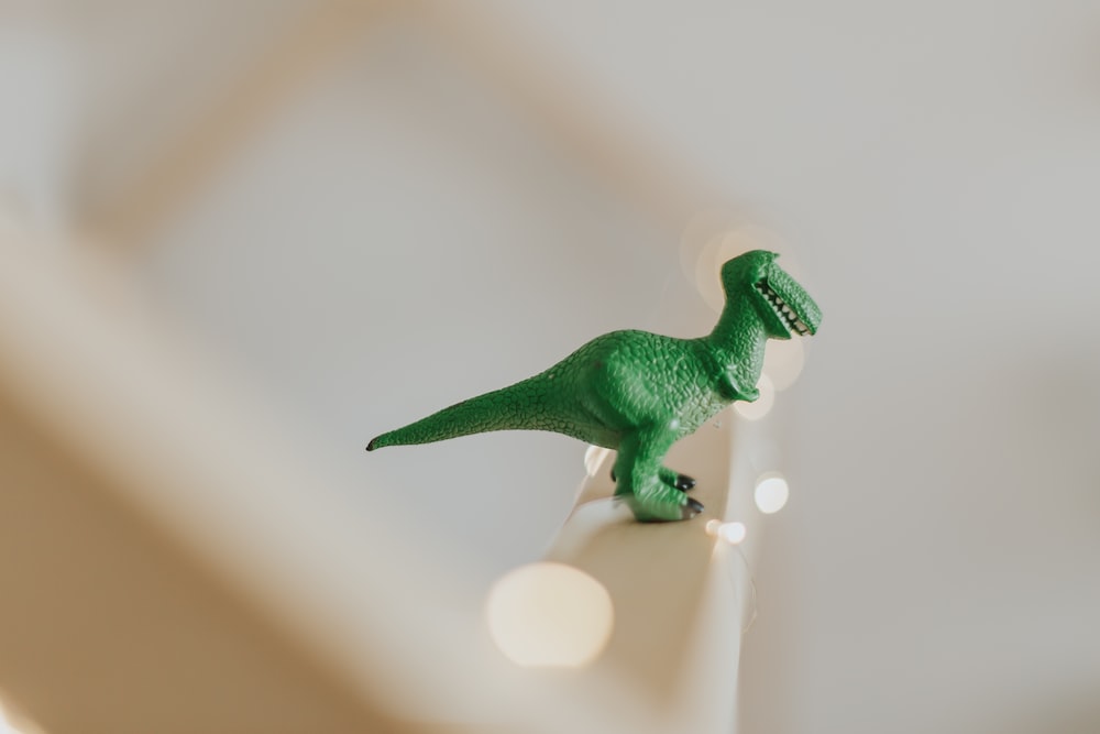 Green T Rex Toy On White Stair Photo Image