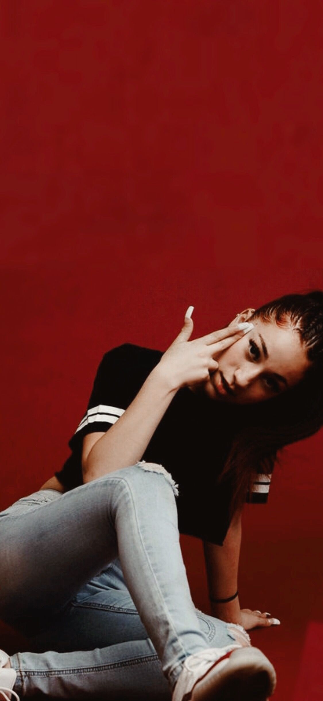Bhad Bhabie posing against a red background