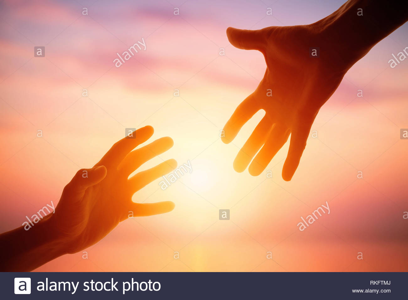 Giving A Helping Hand On The Background Of Dawn Stock Photo