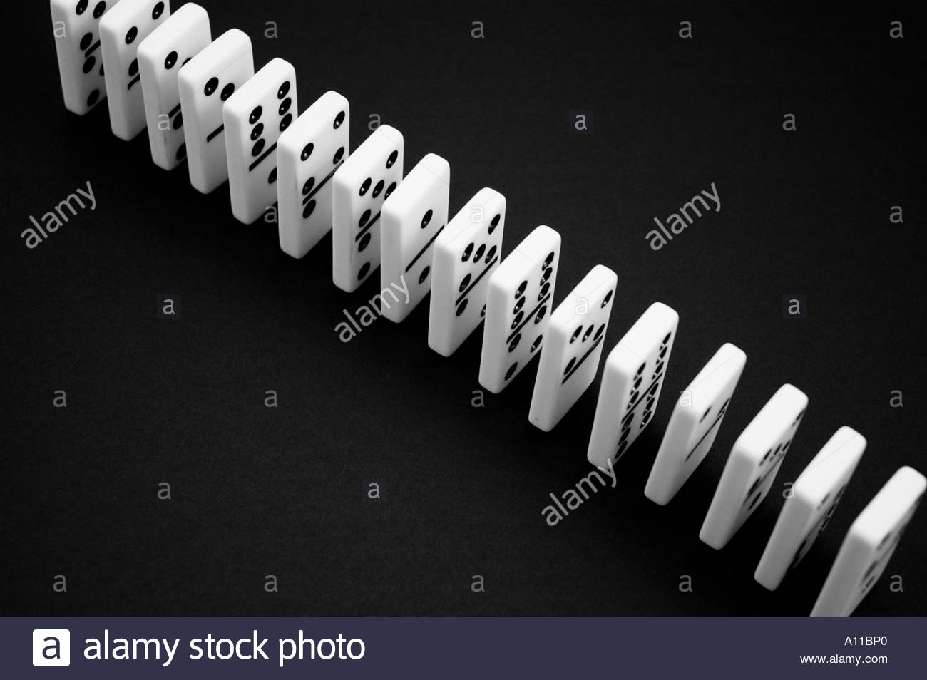 Dominos in a row on a black background Stock Photo 5777823