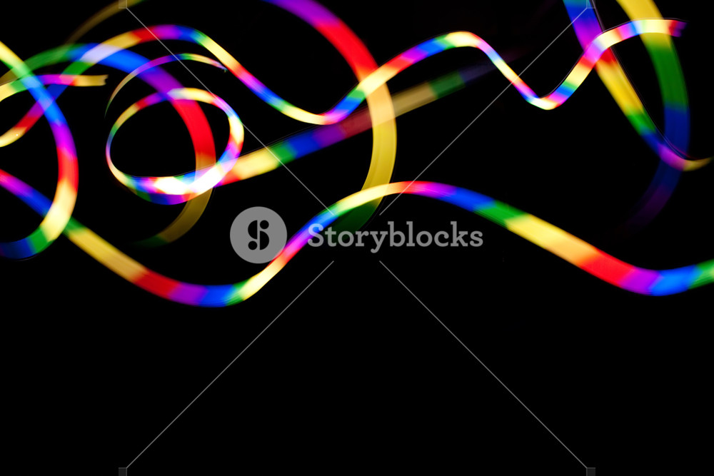Abstract Rainbow Colored Light Streaks Isolated Over A Dark Black