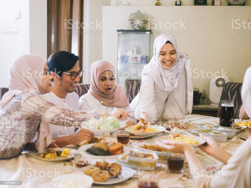 Family Gathering And Eating Together Stock Photo   Download Image