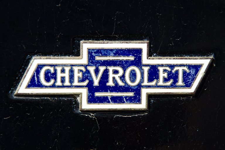 Action Photo Is A Picture Of The Chevrolet Logo On An Old Chevy