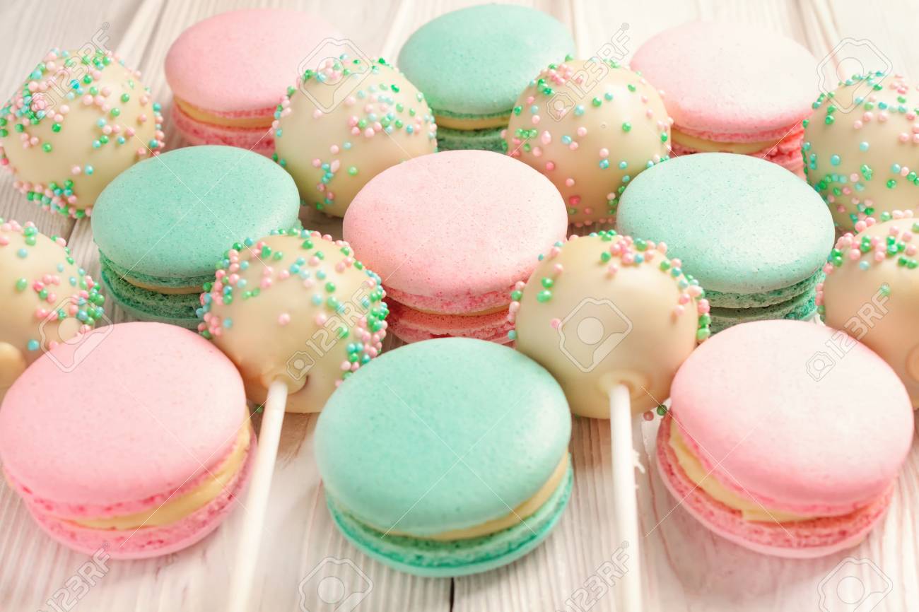 Colorful Macarons And Cake Pops On Sticks White Wooden