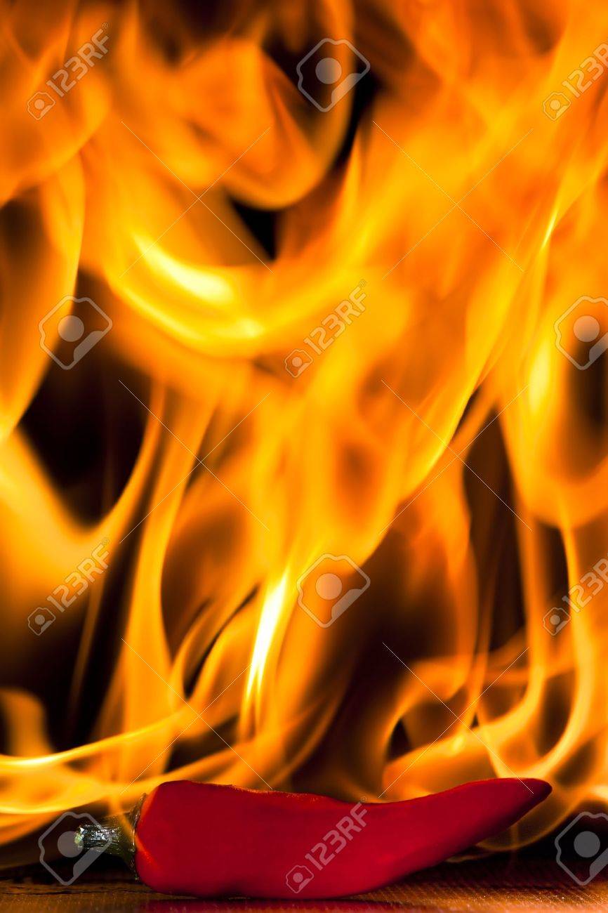 A Chilli Pepper Against Flaming Background Stock Photo Picture