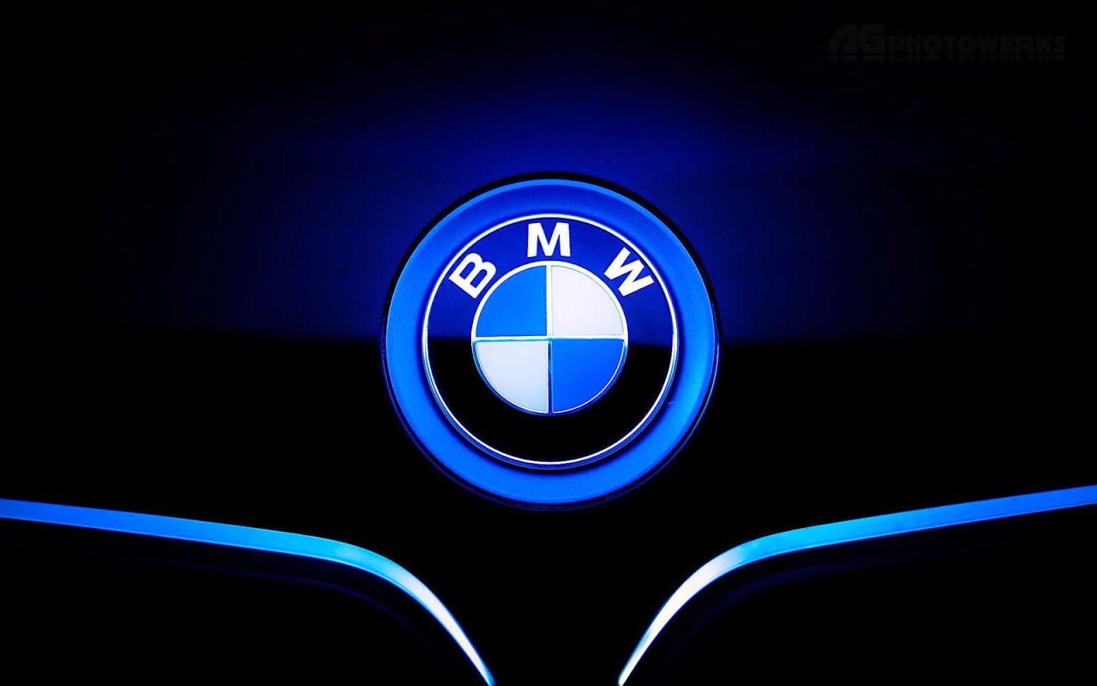 Illuminated BMW Logo on Dark Background