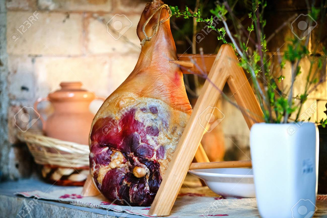 Whole Prosciutto On A Wooden Stand Mediterranean Background Stock