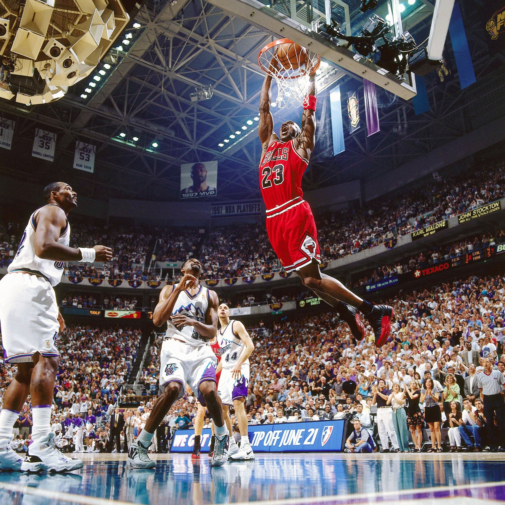 Michael Jordan performing a powerful dunk during an NBA playoff game against the Utah Jazz in 1997