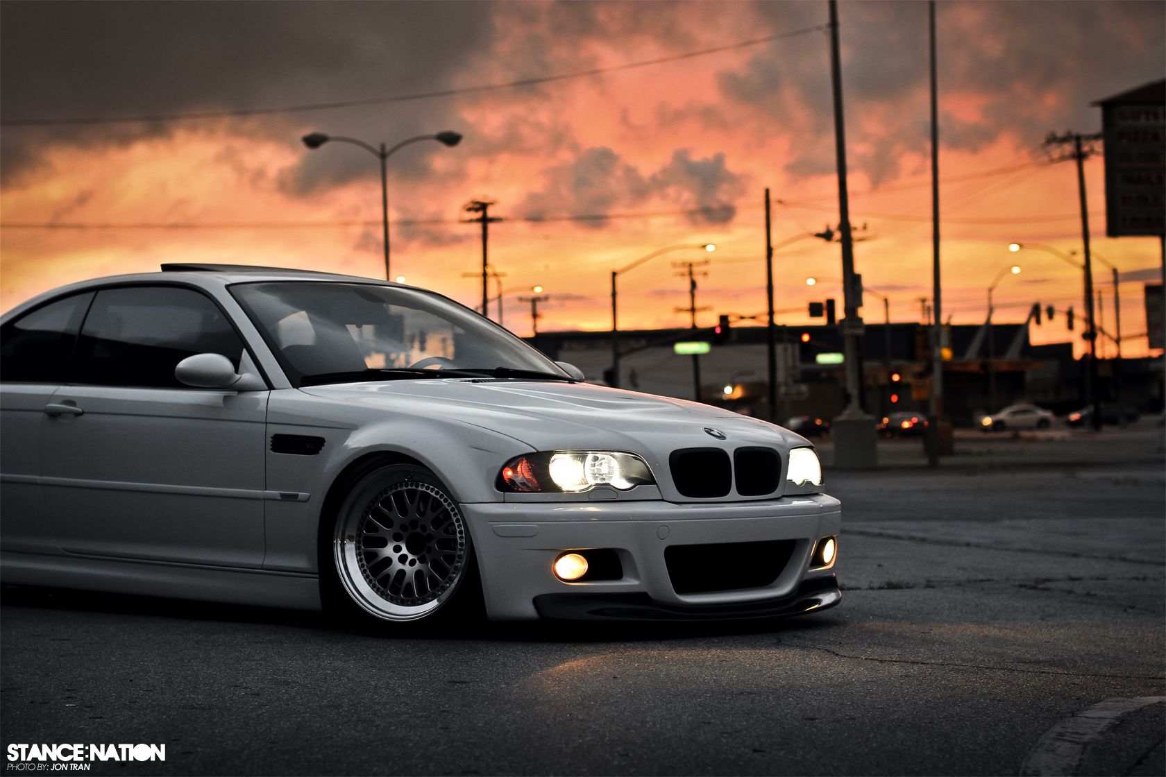 White BMW E46 M3 Coupe parked on a city street at sunset