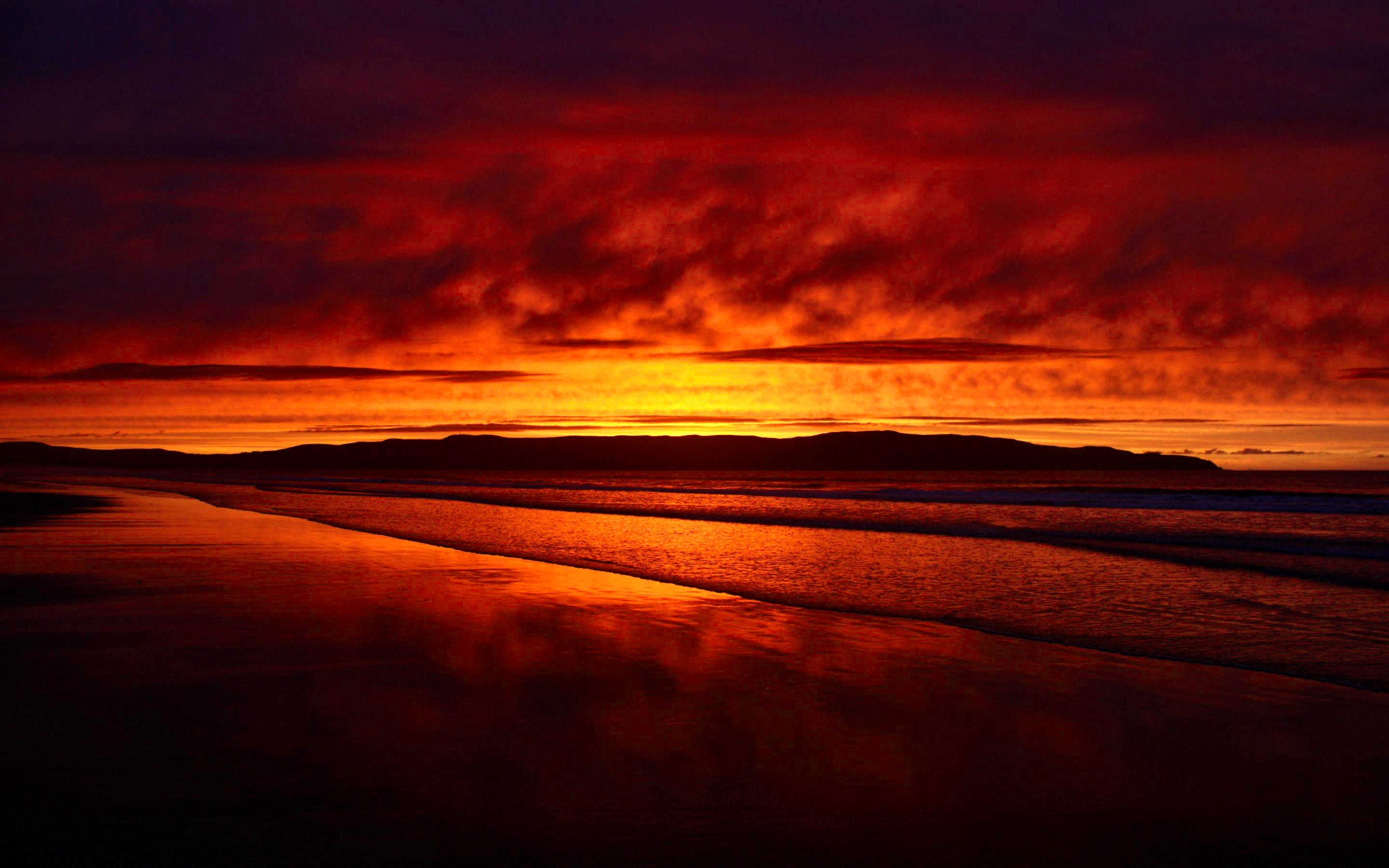 Fiery Sunset over a Tranquil Beach