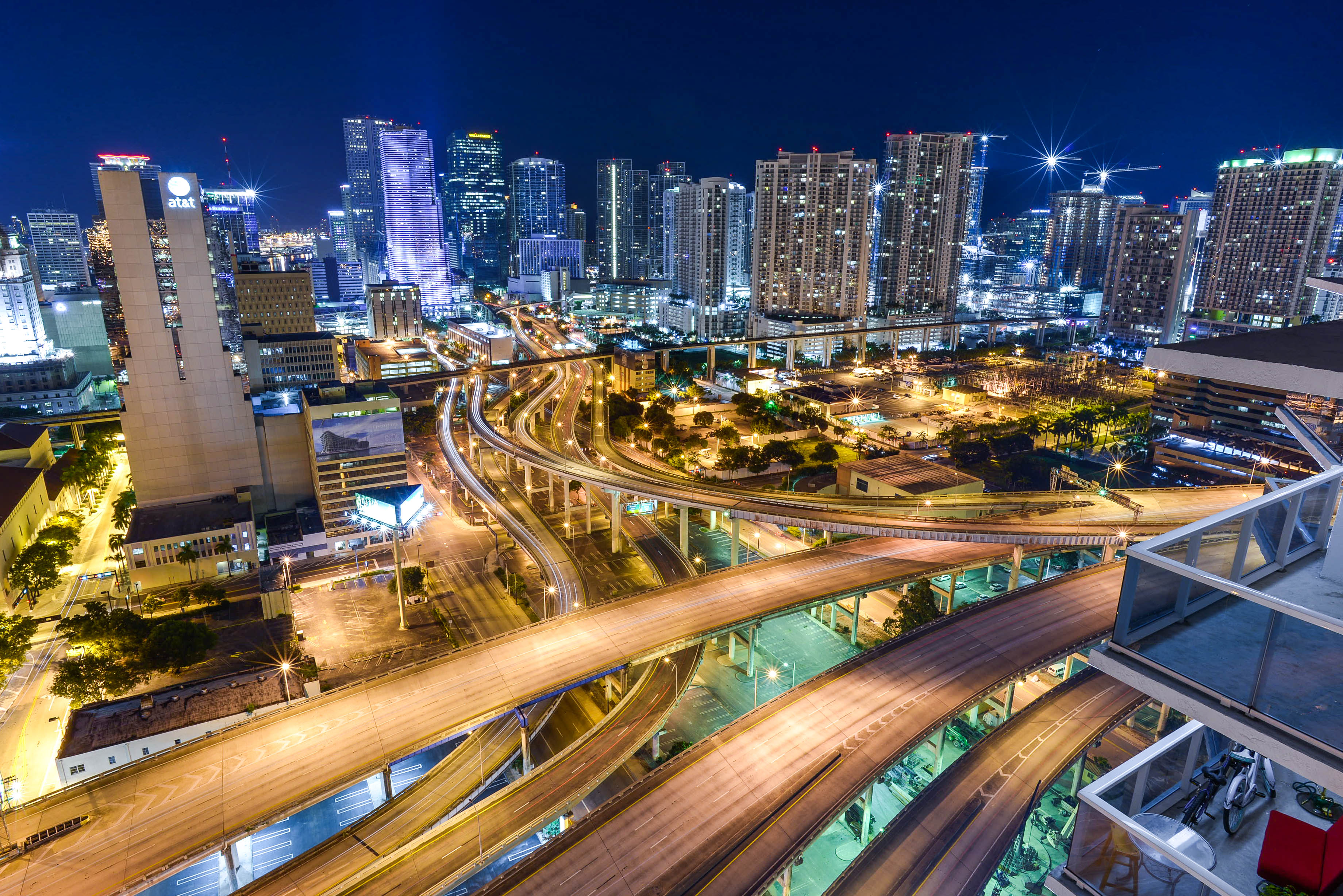 Stunning aerial view of Miami's illuminated skyline and intricate highway system at night