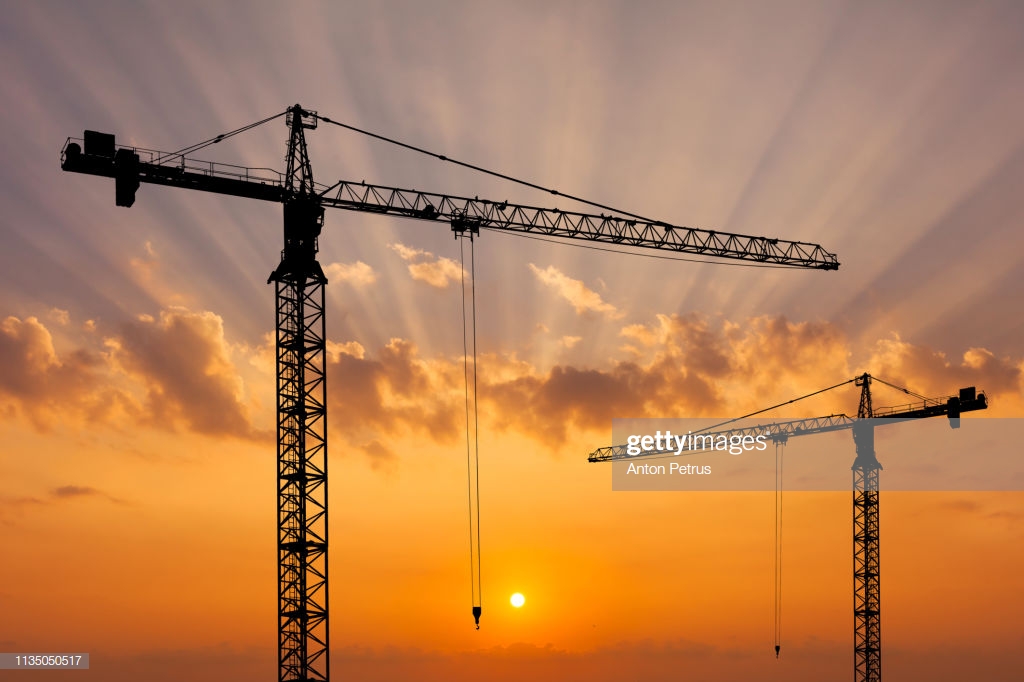 Construction Crane On The Background Of A Beautiful Sky At Sunset