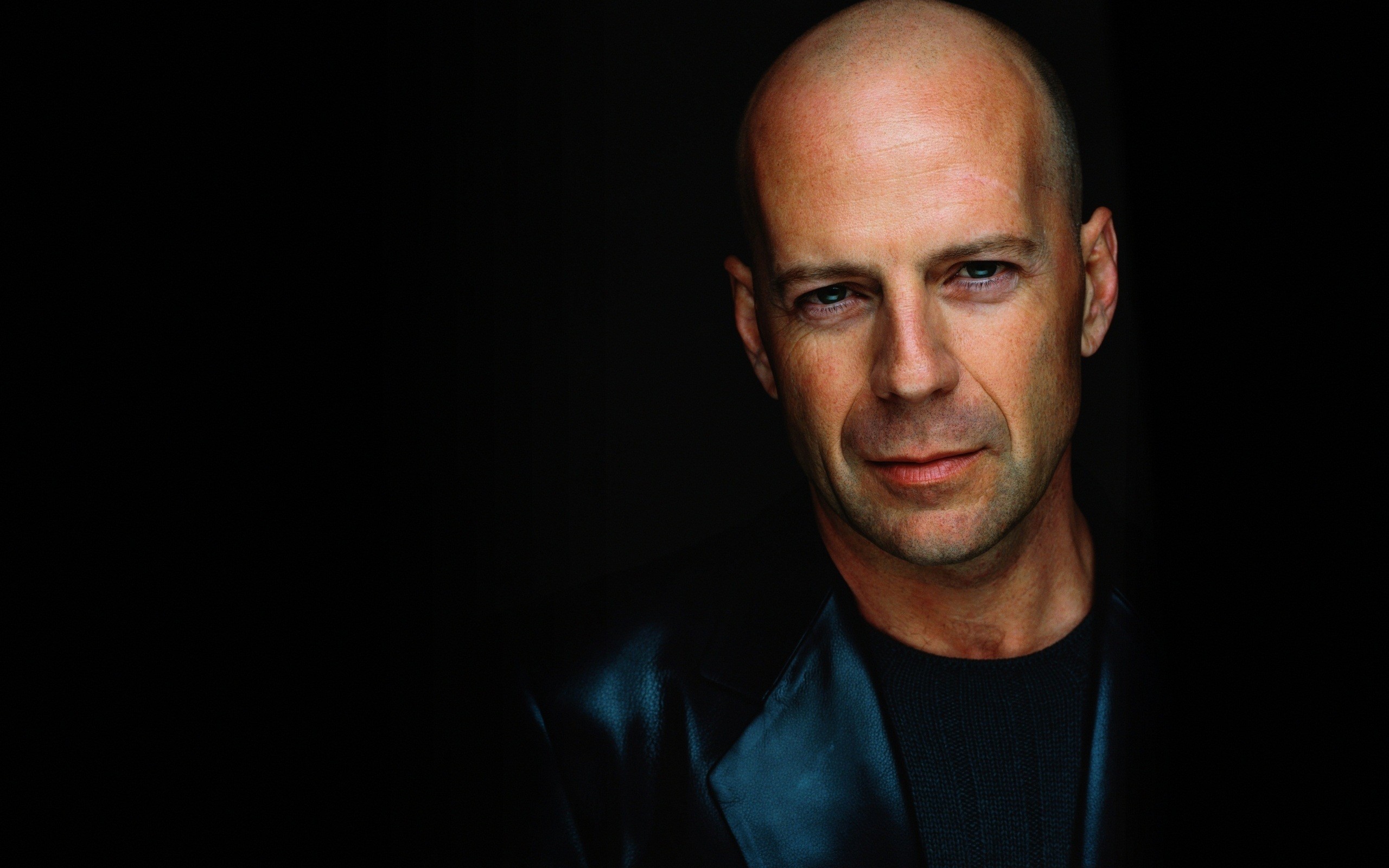 celebrity actors Bruce Willis leather jacket black background