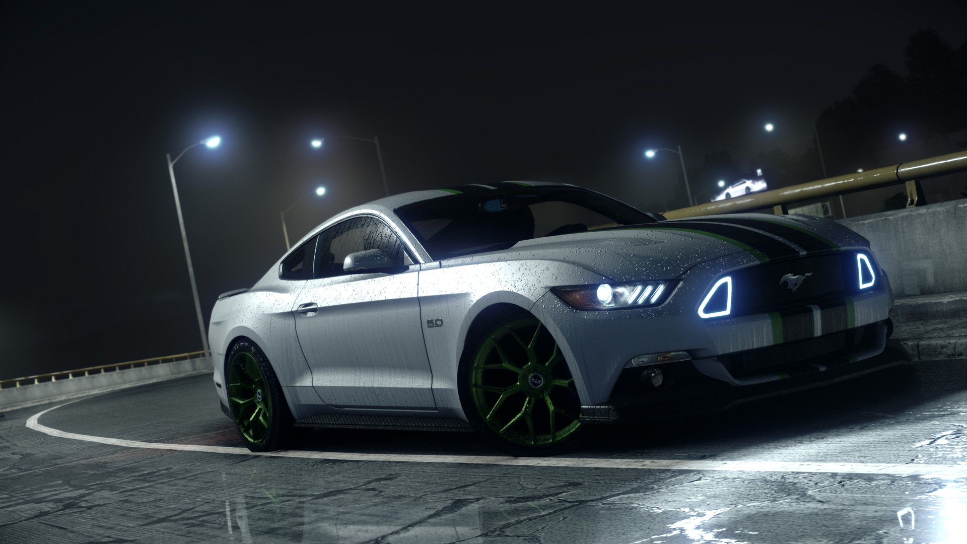 A silver Ford Mustang with green racing stripes parked on a wet road at night