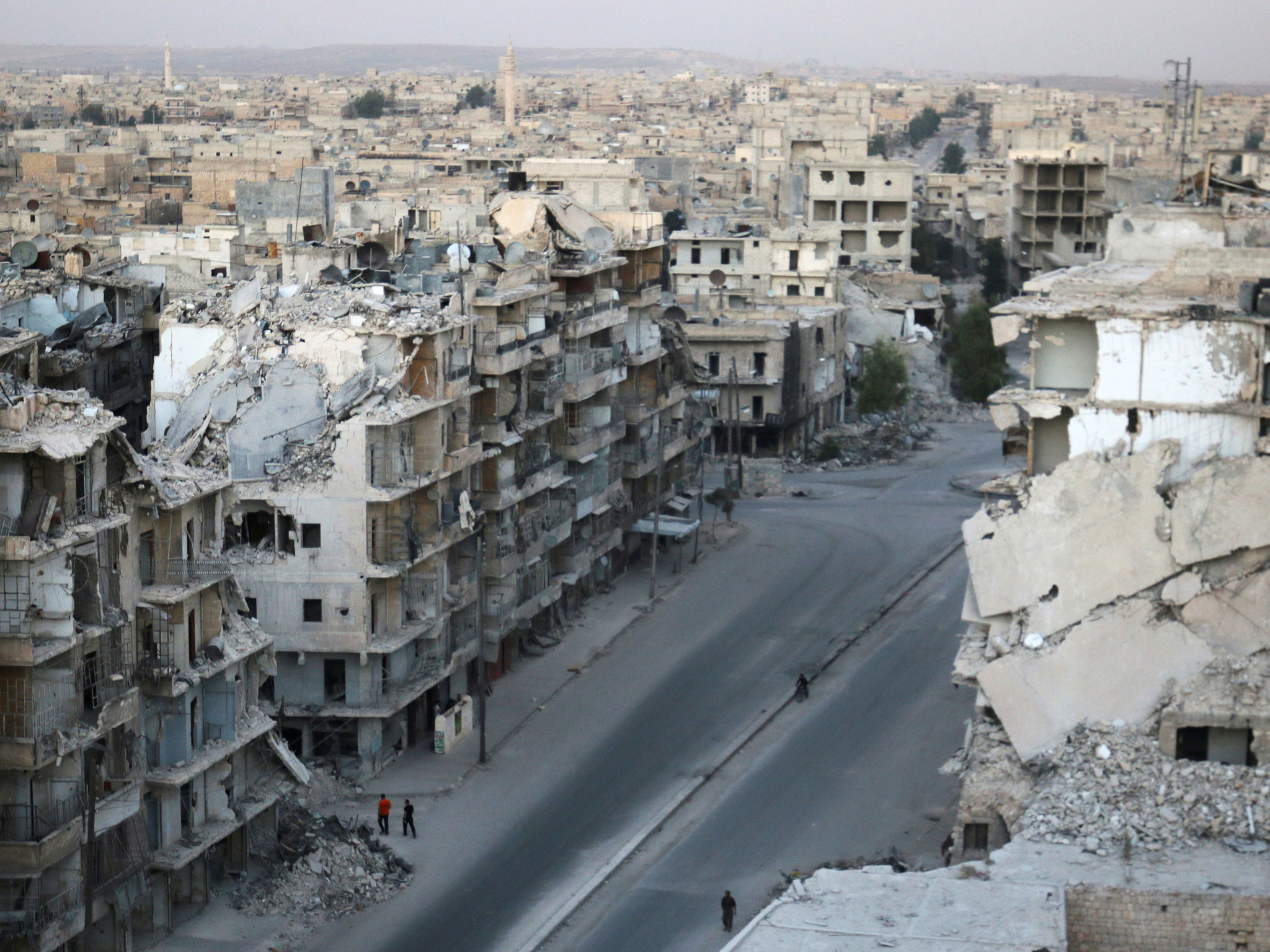 Devastated cityscape of a Syrian city, showing the aftermath of war and conflict with bombed-out buildings and rubble-strewn streets