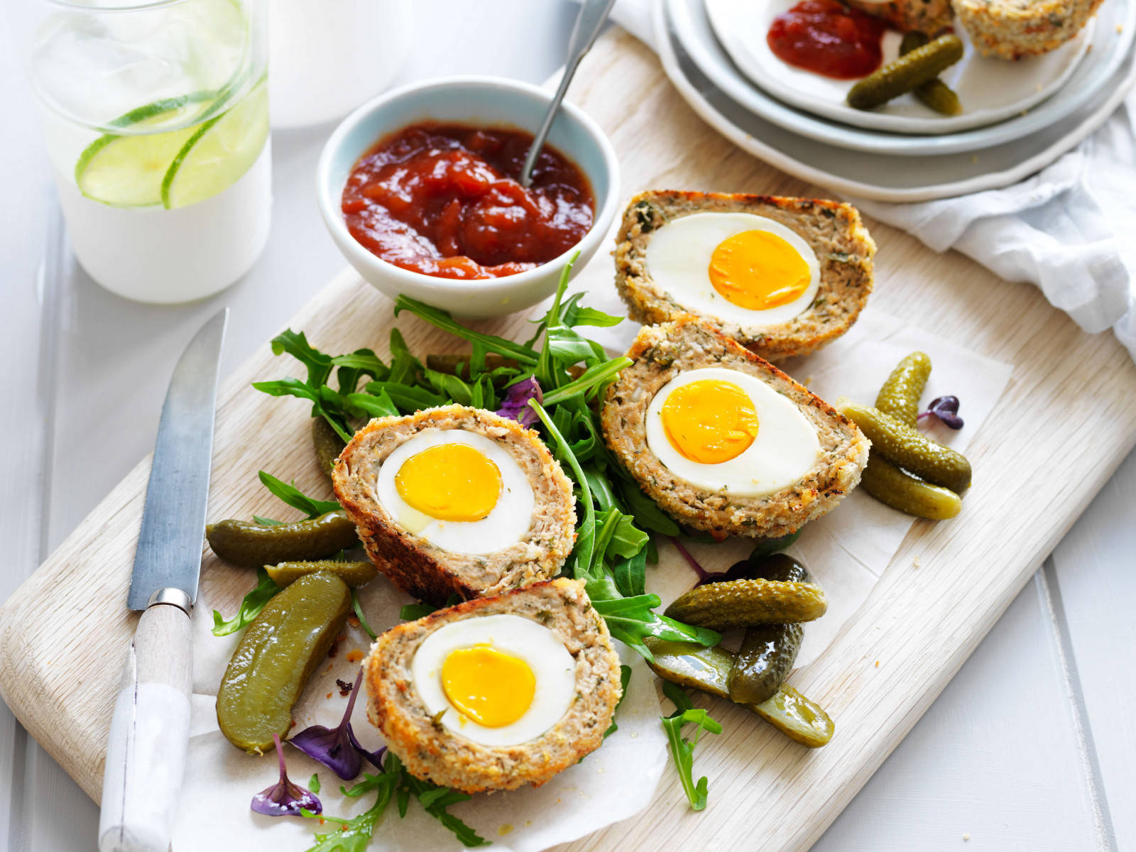 Traditional British Scotch Eggs Dish With Pickles And Wallpaper
